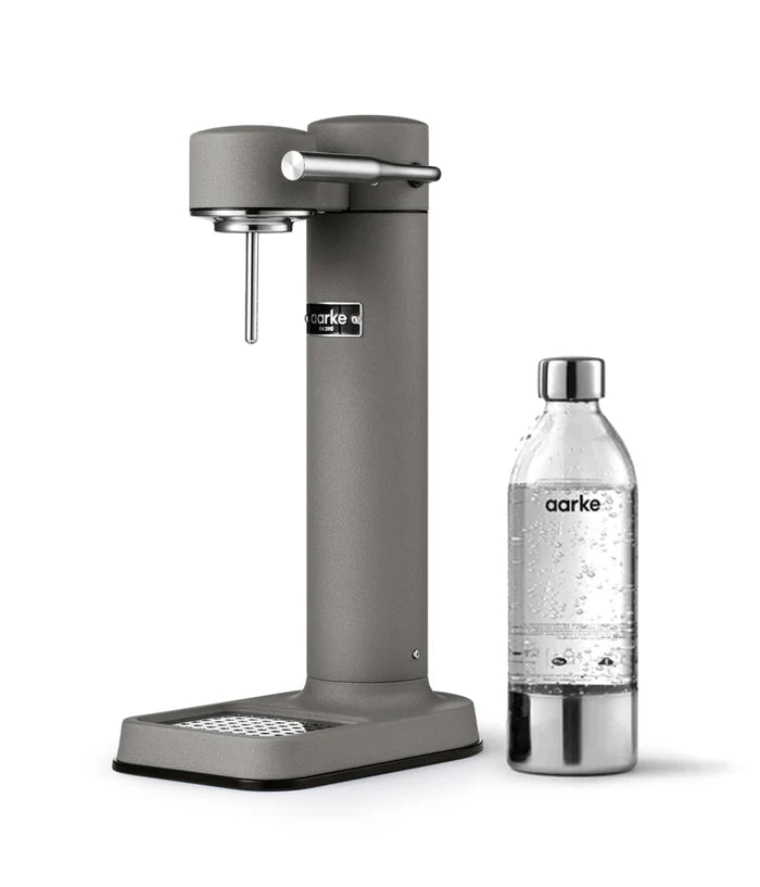 Aarke C3 Carbonator 3 in Matte Grey with a stainless-steel finish, featuring a pouring spout and a water bottle attached beneath it.